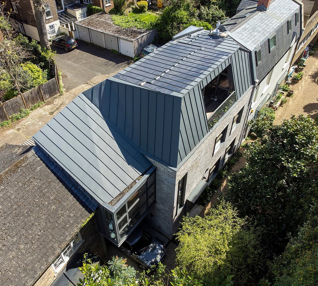 Striking black metal roof and angular architectural features on a residential building.