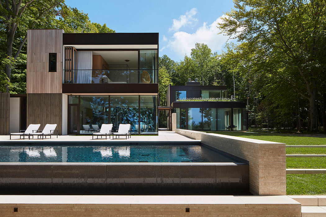 Sleek modern architecture with extensive glass walls, cantilever roofs, and a sizable swimming pool.