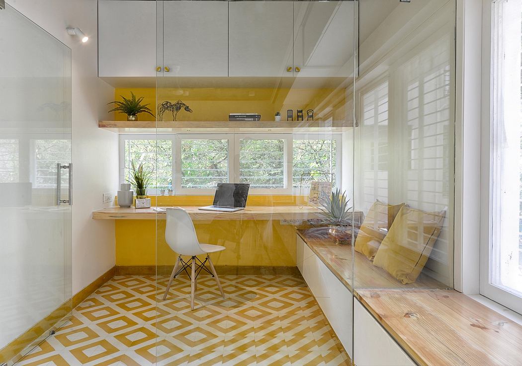 Sleek, modern home office with bright yellow accent wall and geometric tile flooring.
