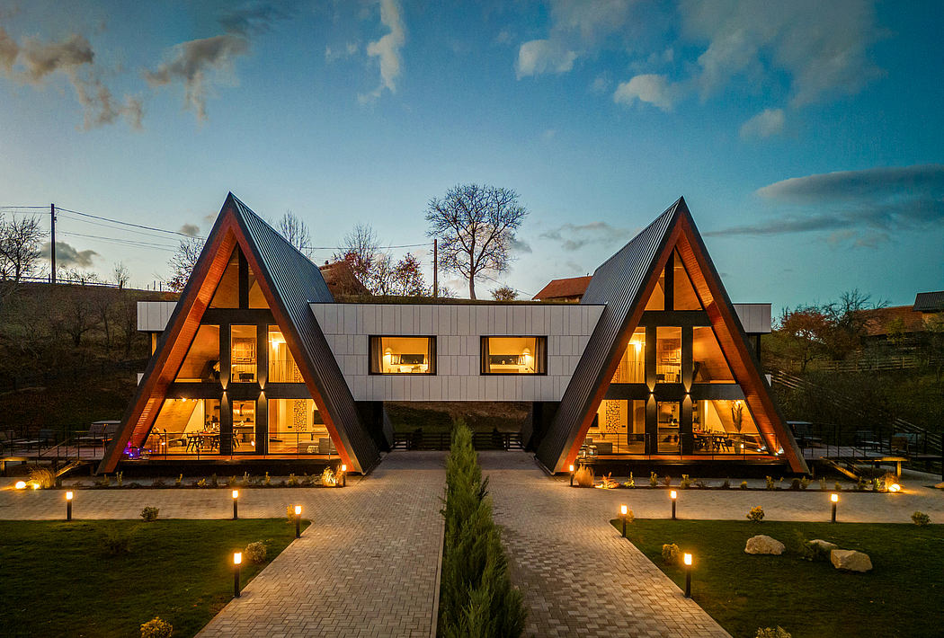 A unique, A-frame architectural design with warm lighting and cozy interiors.