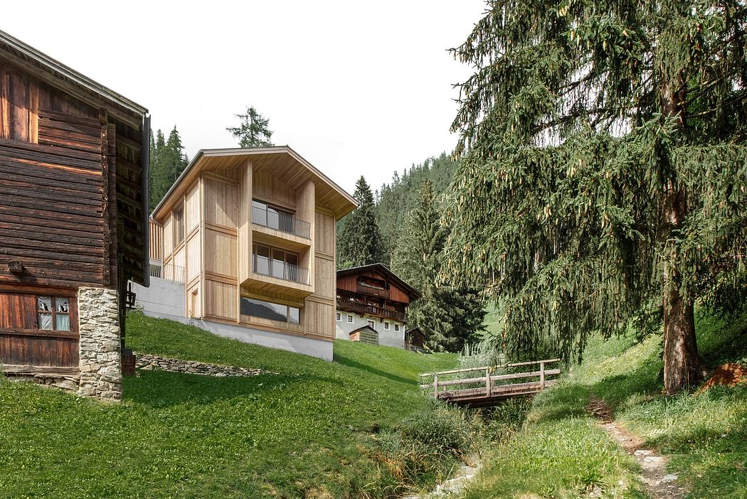 A rustic alpine chalet nestled in a lush forest, featuring wooden construction and balconies.