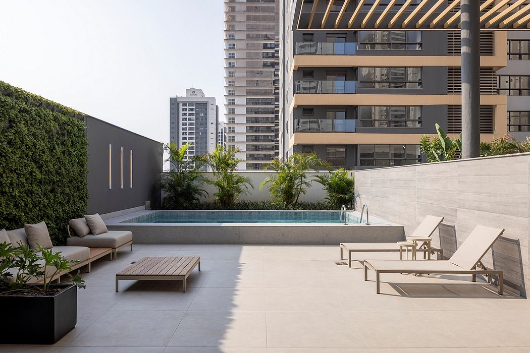 Sleek, modern outdoor space with minimal pool, seating, and tropical foliage.