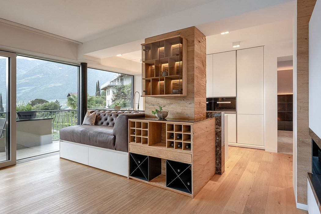 Minimalist living room with wooden shelving, storage, and mountain view through large window.