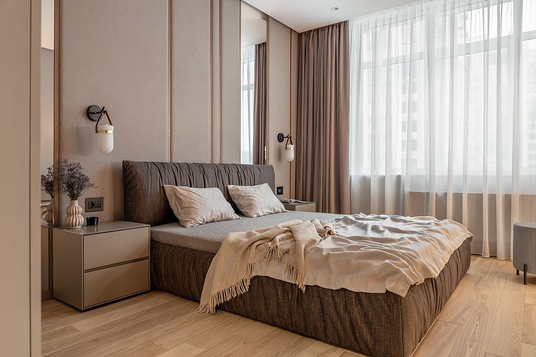 Cozy bedroom with plush bedding, modern lighting fixtures, and large window providing natural light.