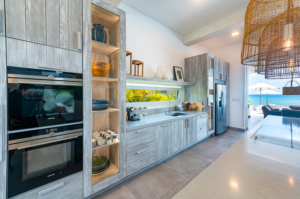 A modern, high-end kitchen with sleek wood cabinetry, built-in appliances, and an open layout.