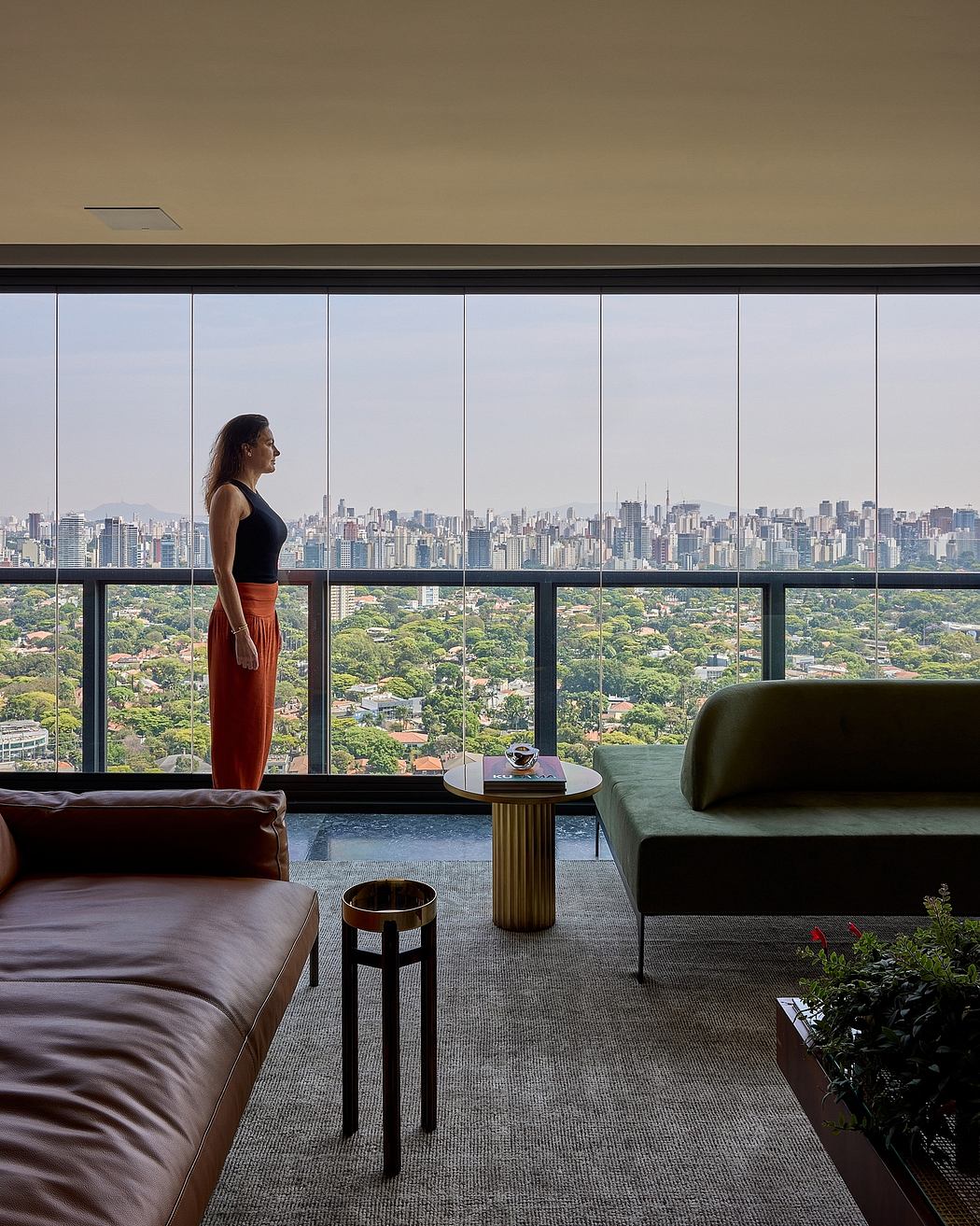Expansive urban skyline framed by floor-to-ceiling windows, with a modern, minimalist interior design.