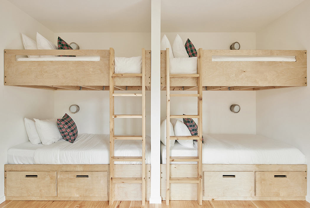 Rustic wooden bunkbeds with built-in storage drawers and plaid accent pillows.