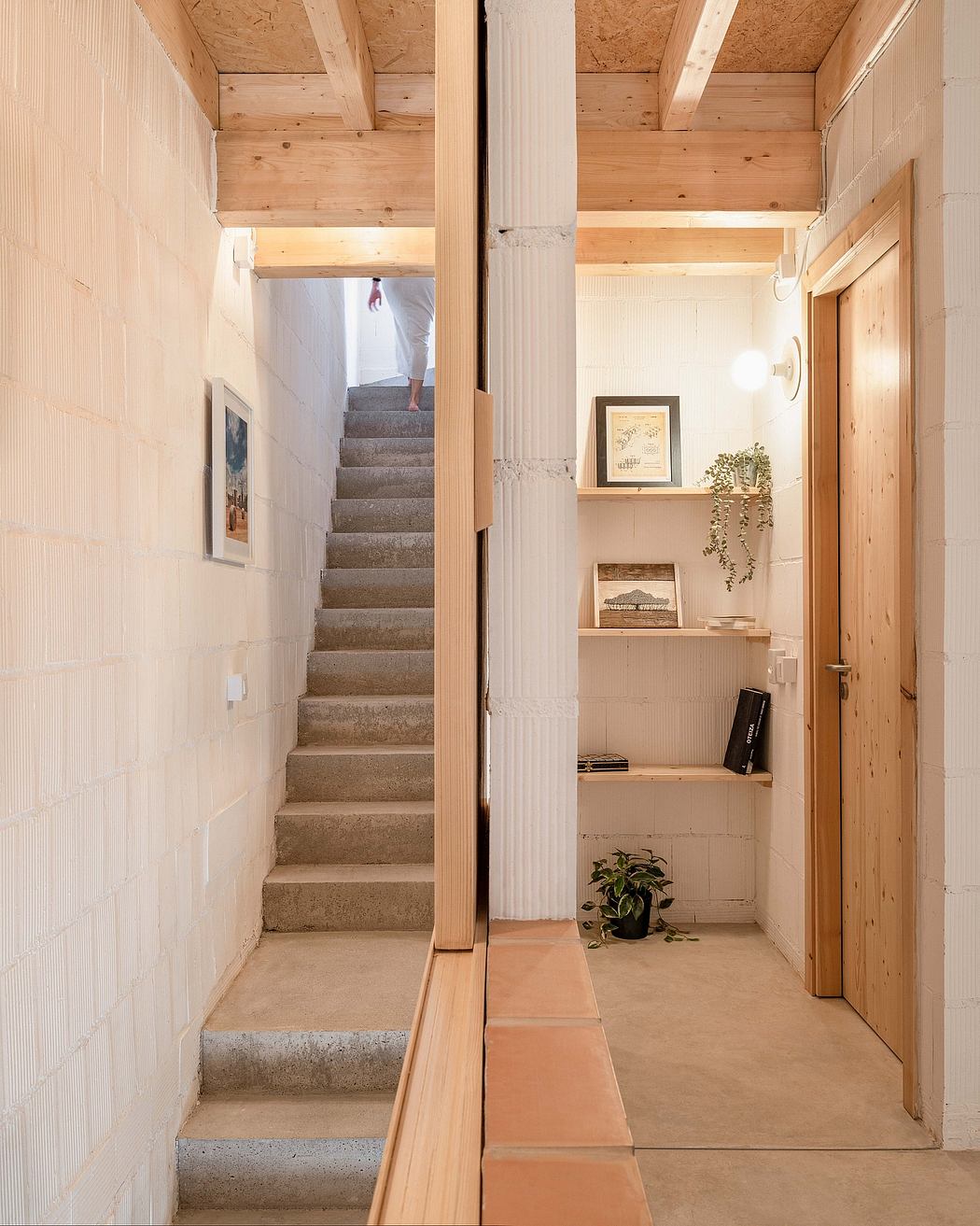 Rustic wooden ceiling and staircase with shelving and decor in cozy hallway.