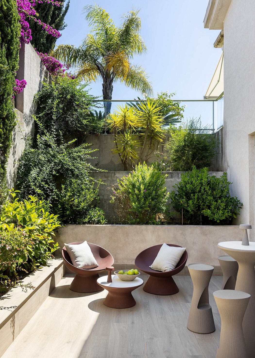 Tranquil oasis with lush greenery, sleek outdoor furniture, and minimalist decor.