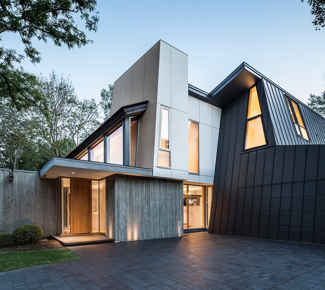 Modern, angular architecture with wood and black metal accents. Expansive glass windows and an inviting entrance.