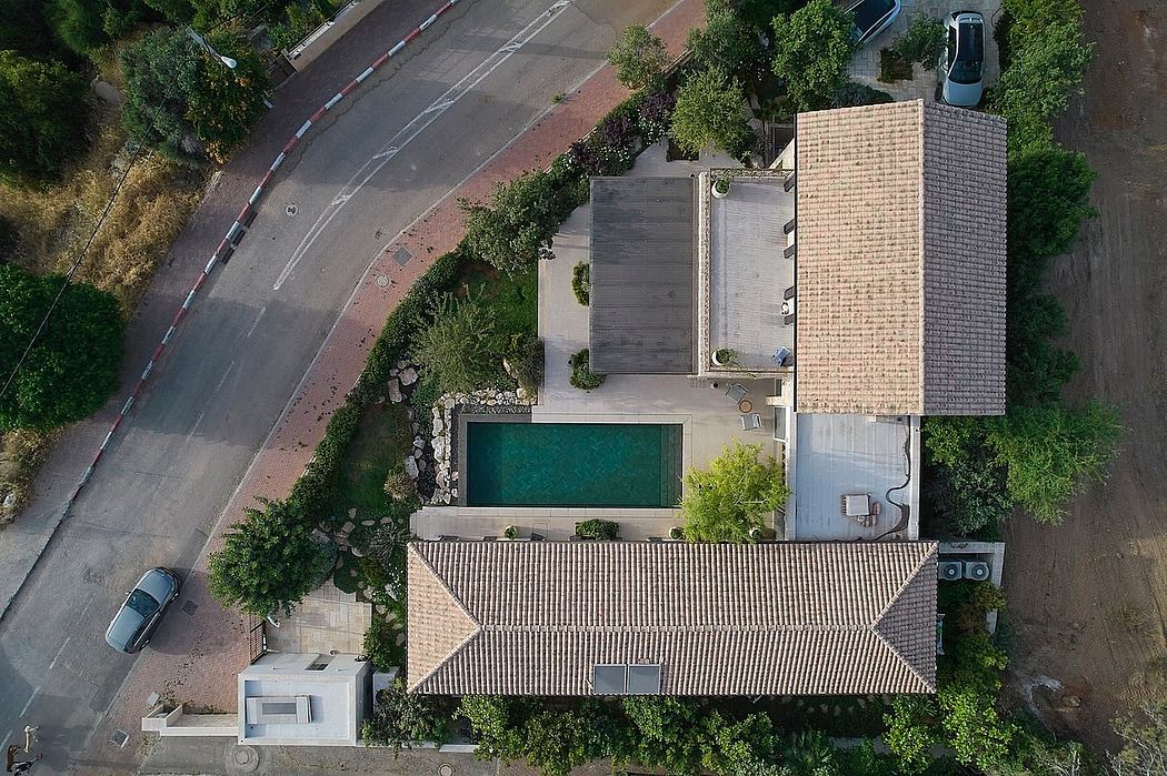 Aerial view of modern residential building with swimming pool and landscaping.