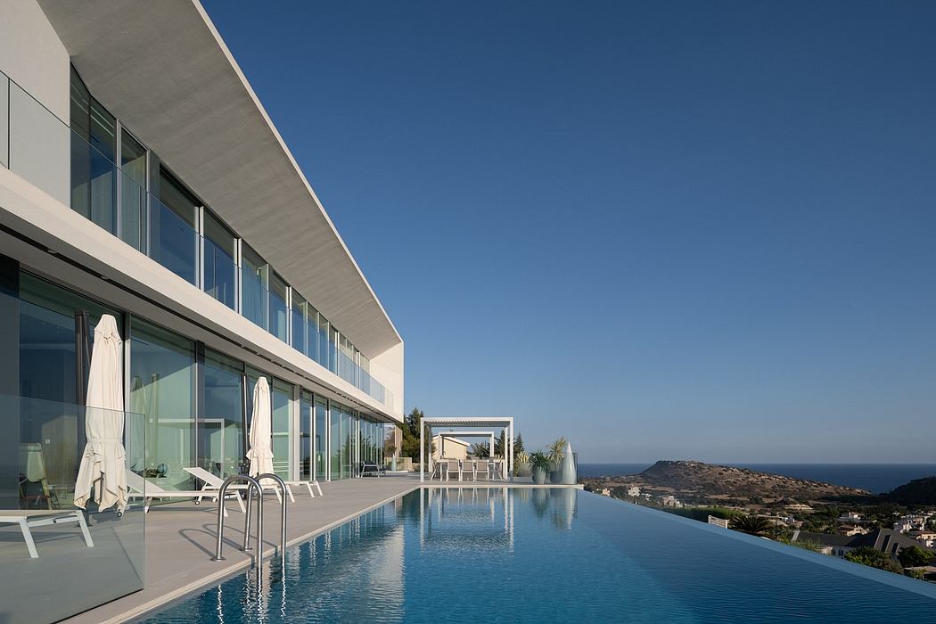 Captivating modern architecture with infinity pool overlooking scenic coastal vista.