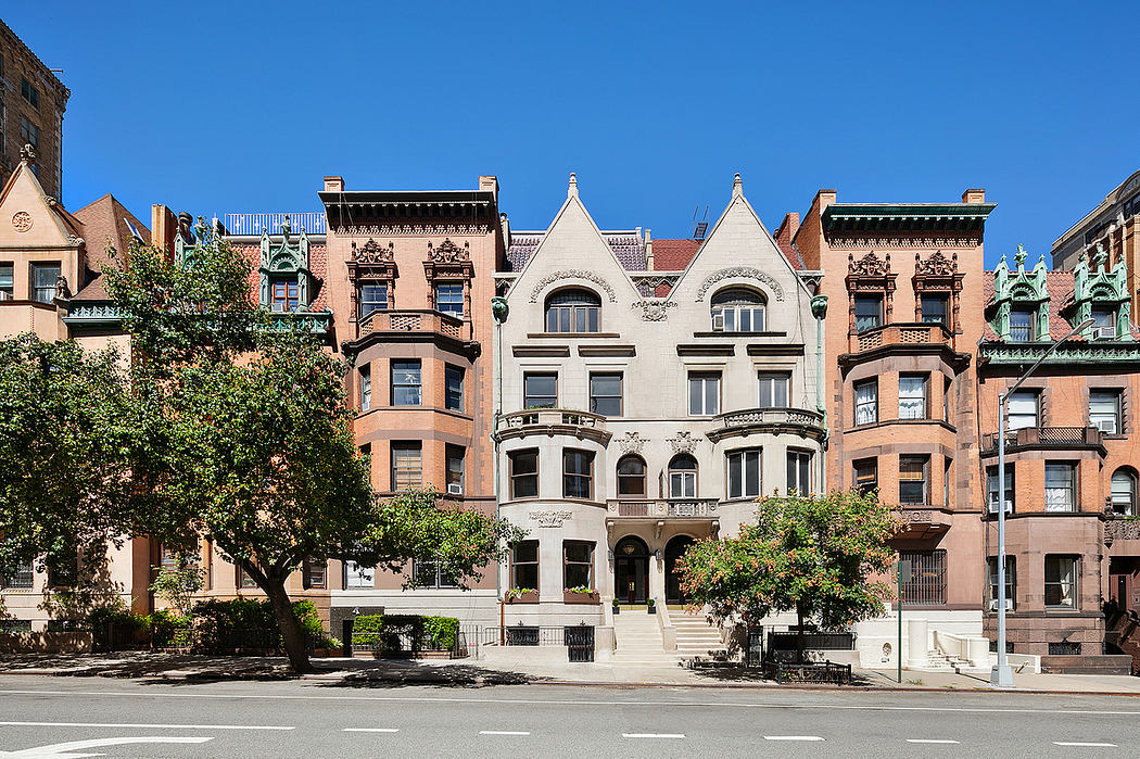Ornate Romanesque-style buildings with intricate stone facades, turrets, and decorative elements.