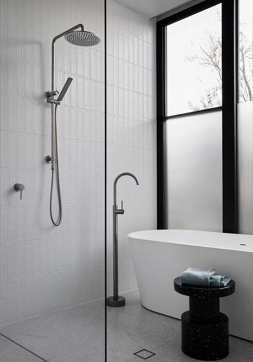 Minimalist bathroom with sleek, modern fixtures and a freestanding bathtub.