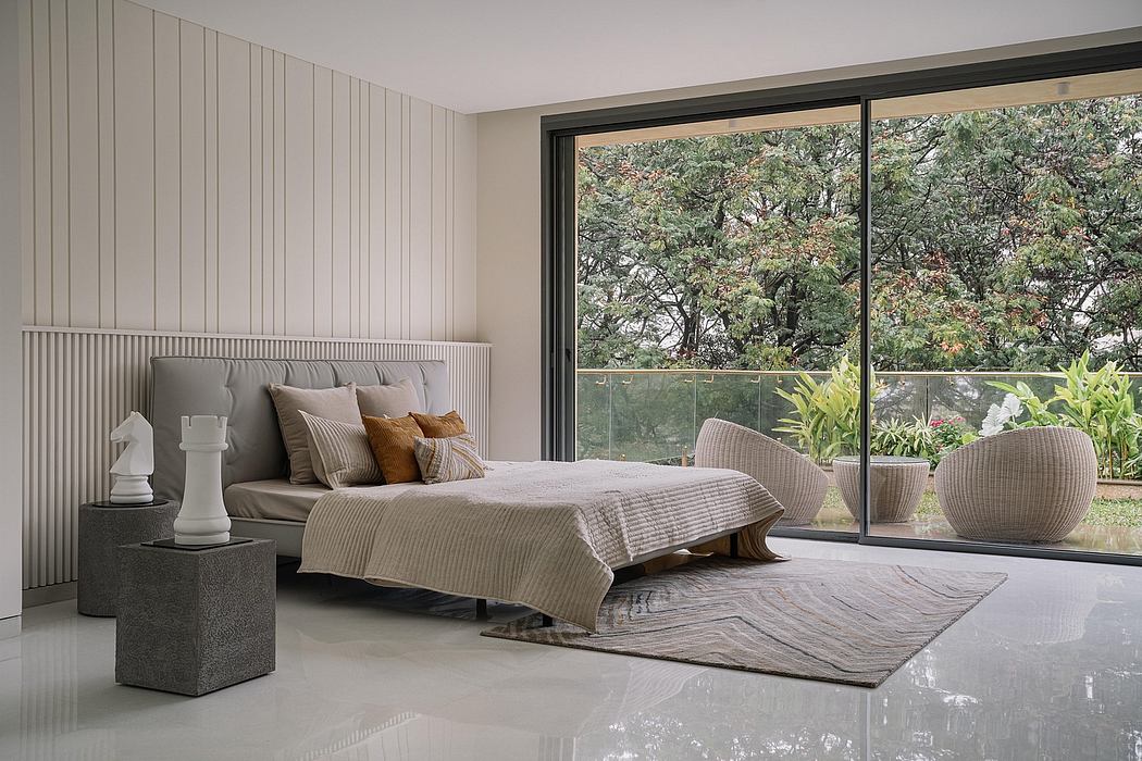 Modern bedroom with floor-to-ceiling windows, plush bedding, and minimalist decor accentuating the natural surroundings.
