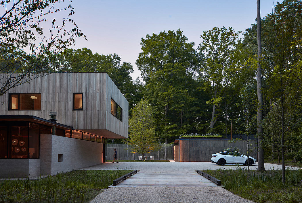 Sleek, modern architecture with wooden cladding, open walkways, and a parked vehicle.