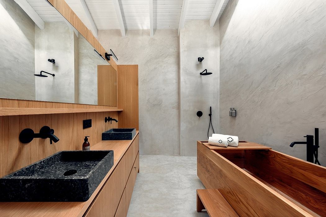 Minimalist bathroom design with contrasting light and dark wood tones, concrete walls, and black fixtures.