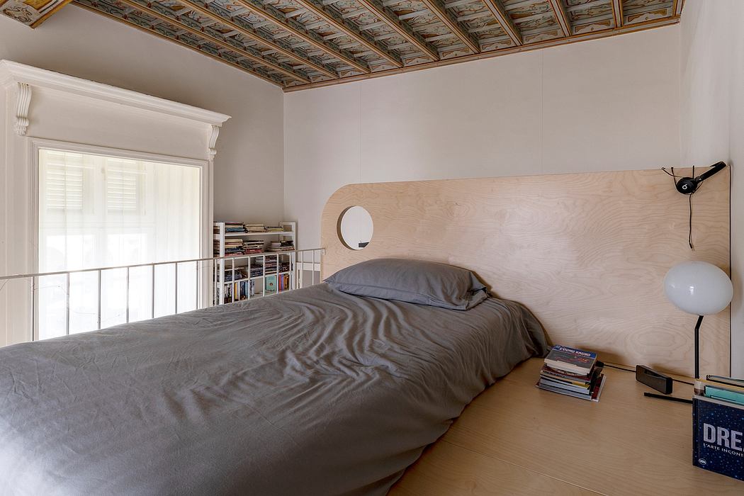 Ornate wood-beamed ceiling contrasts with minimalist wood headboard and shelving.