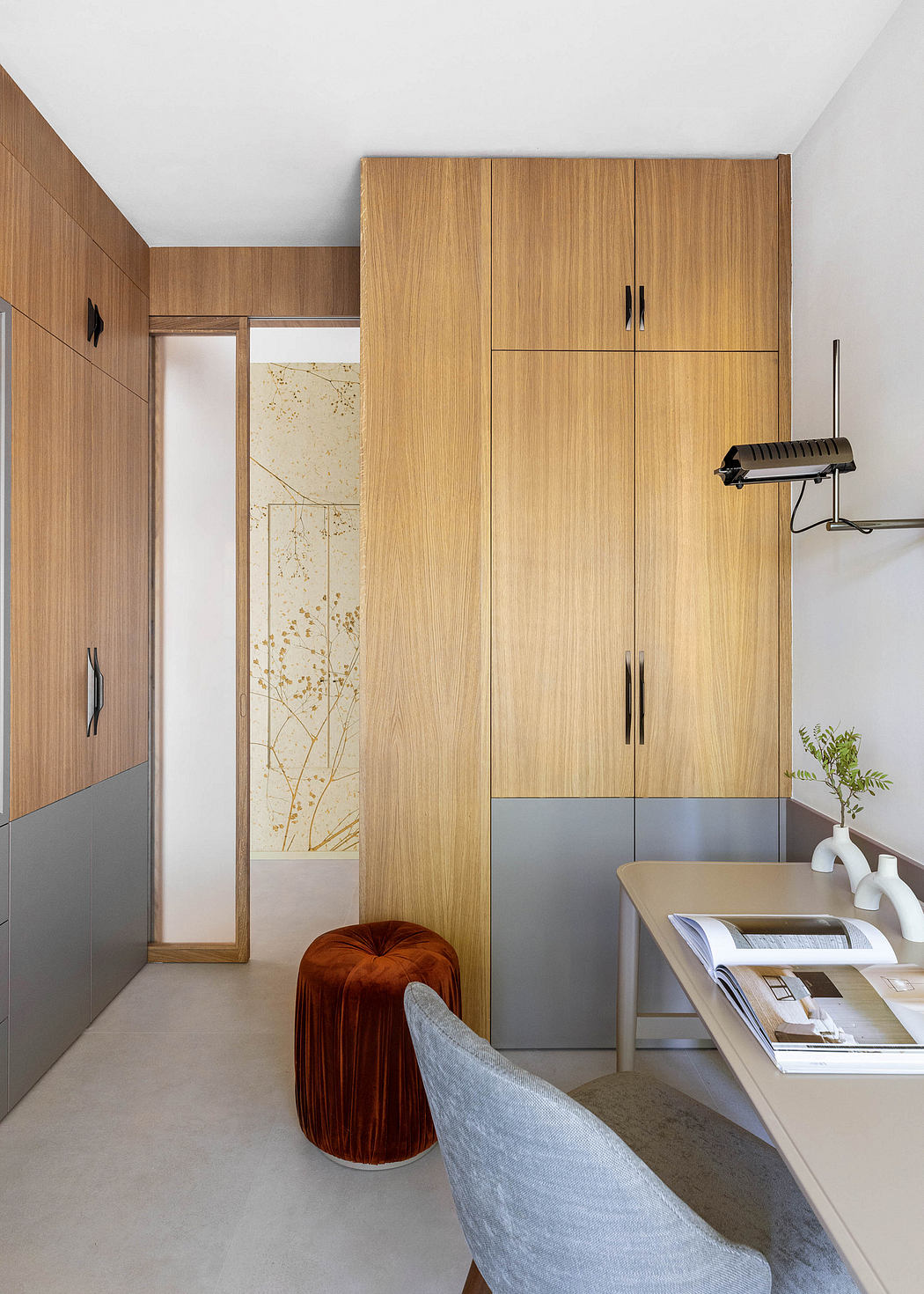 A contemporary interior with wooden cabinetry, minimalist furniture, and a vibrant color palette.
