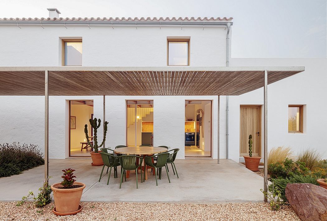 Warm-toned modern exterior with bamboo-slat canopy, potted plants, and open-plan interior.