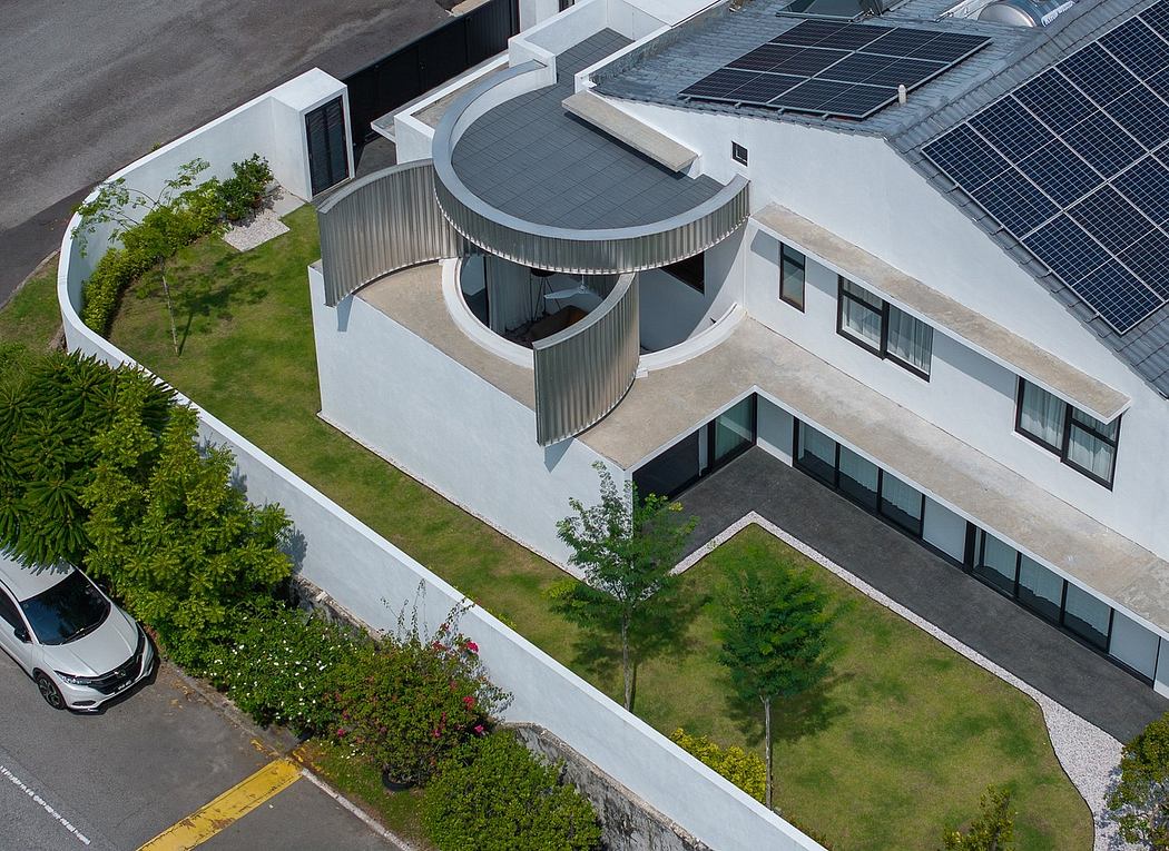 Modern eco-friendly building with curved solar panels, balconies, and green landscaping.