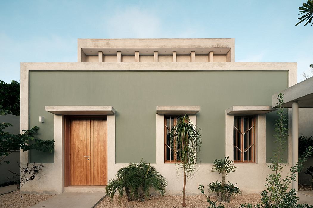 Minimalist desert-inspired architecture with wooden doors, palm trees, and desert landscaping.