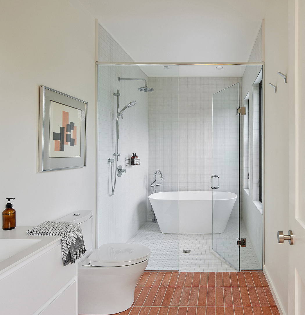 Spacious, modern bathroom with a freestanding tub, glass shower enclosure, and sleek fixtures.