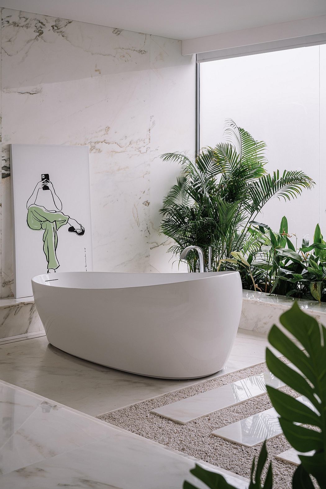 Sleek white bathtub, lush tropical plants, and a modern marble-clad wall create a serene spa-like space.