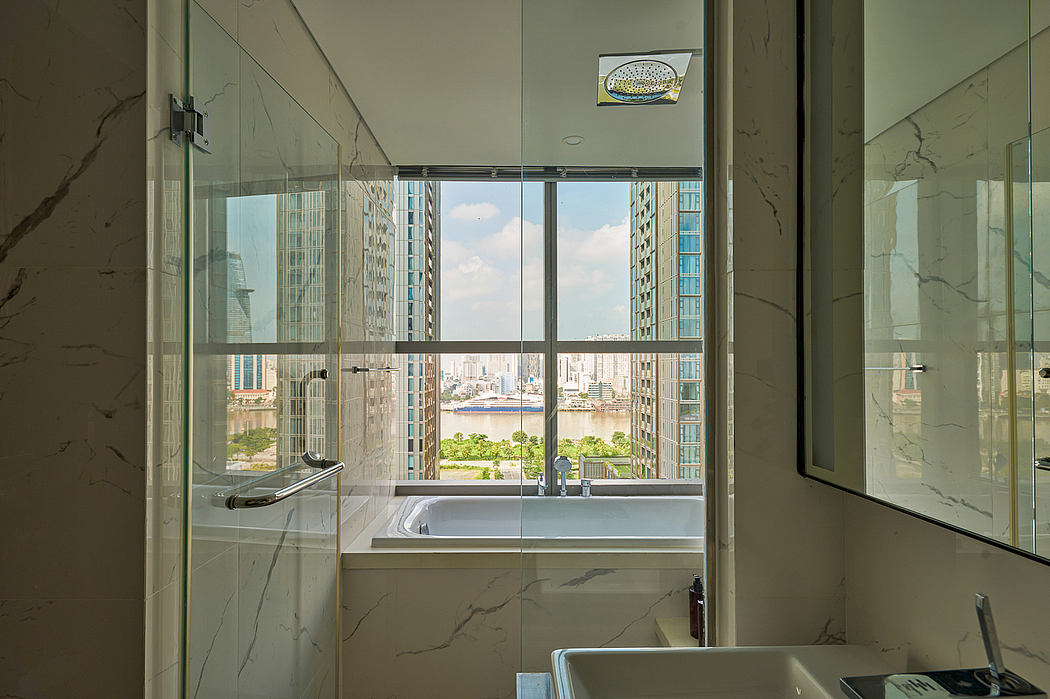 Luxurious bathroom with expansive city views through floor-to-ceiling windows.