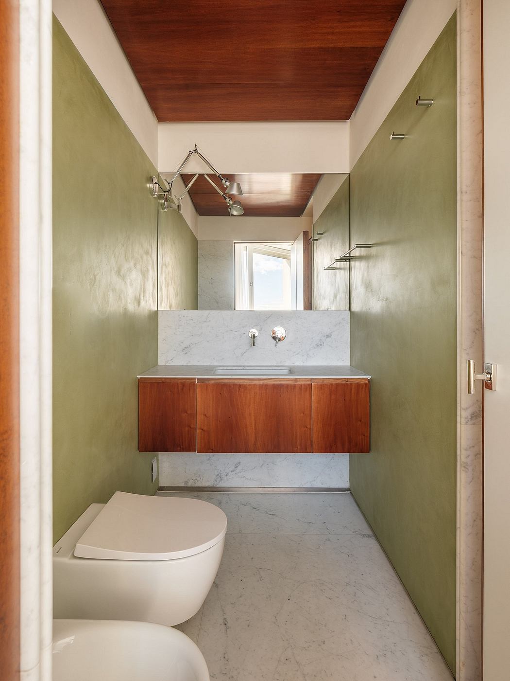 Sleek marble vanity and wood ceiling define this modern bathroom's refined aesthetic.