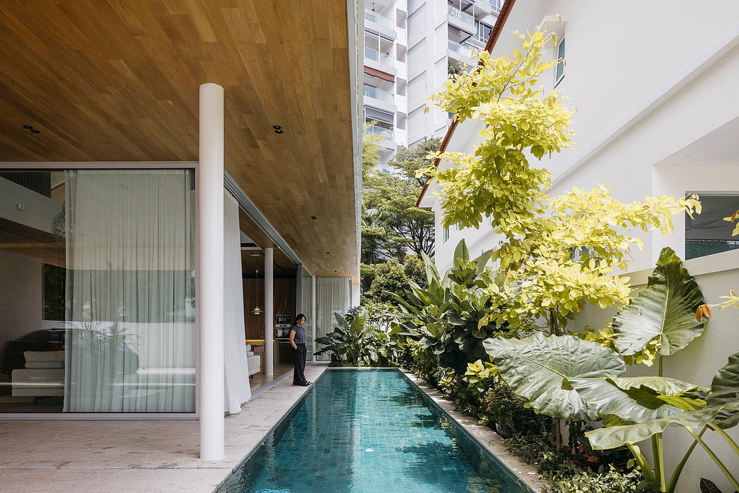 Lush indoor pool surrounded by tropical greenery and modern architectural elements.