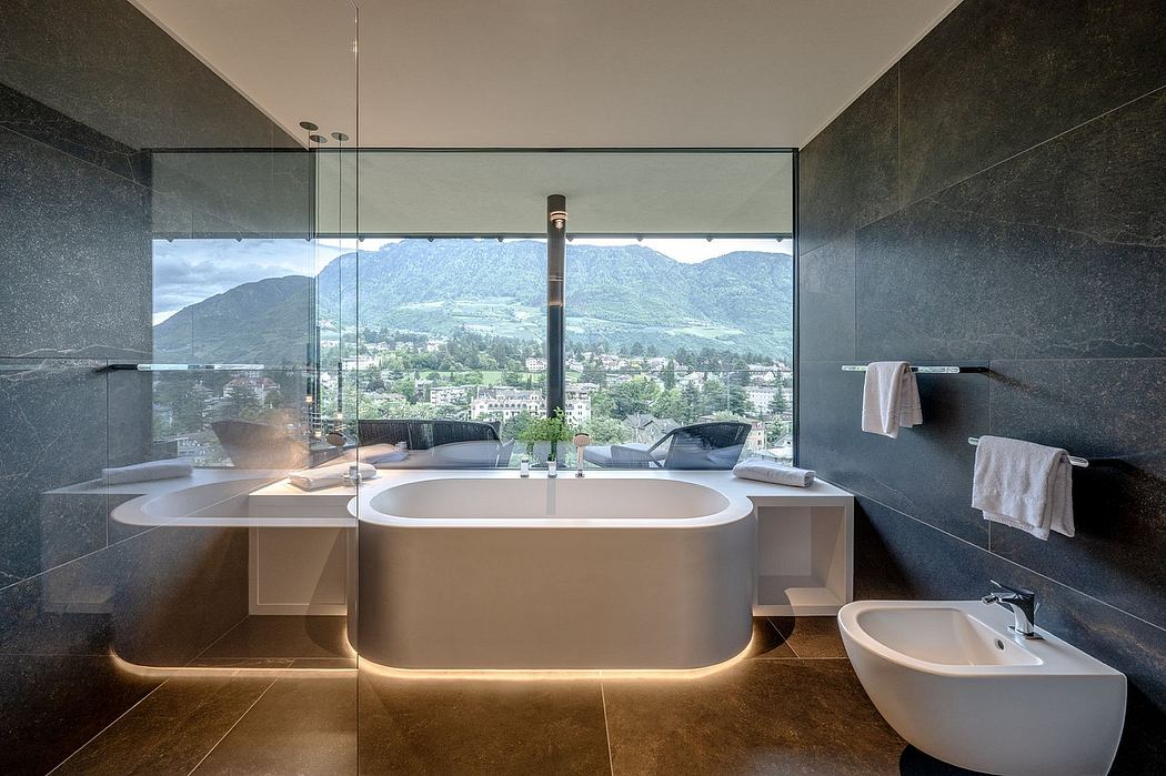 Luxurious bathroom with a stunning mountain view, modern fixtures, and minimalist design.