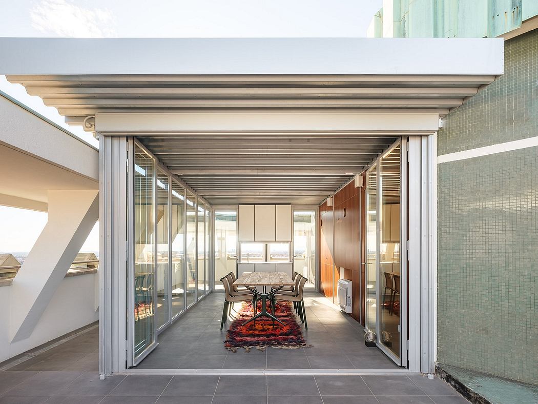 Sleek, modern architectural details of an interior space with floor-to-ceiling glass walls, wood and metal accents, and a stylish rug.