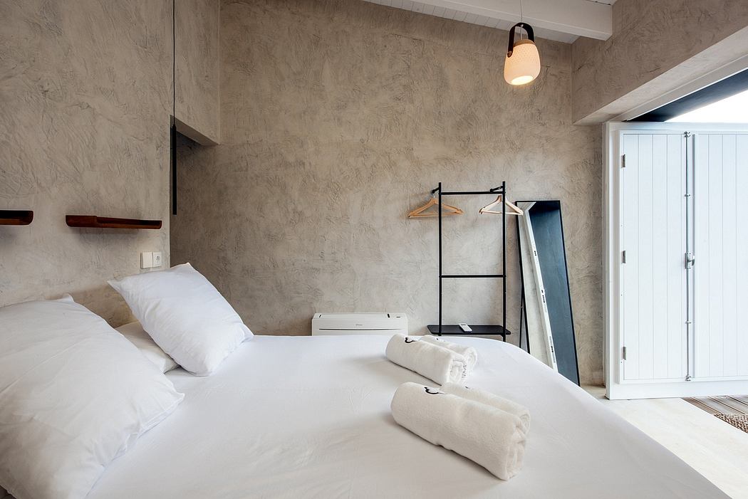Minimalist bedroom design with cement-based walls, wooden shelves, and a clean, simple layout.