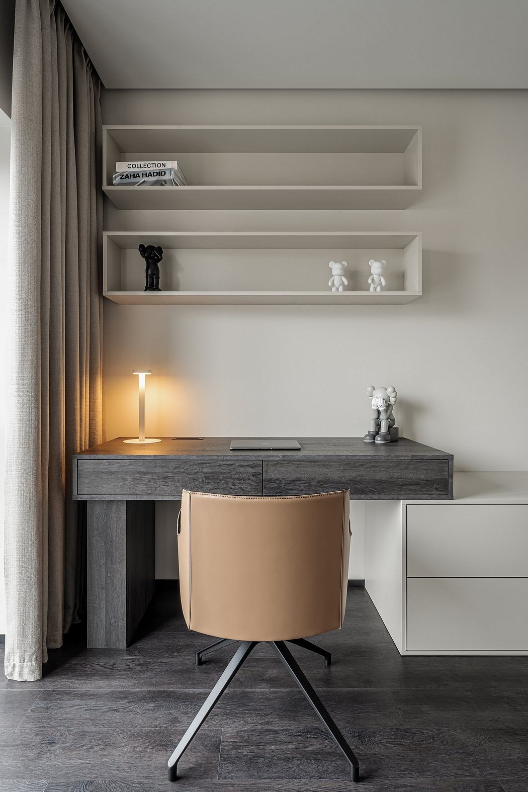Minimalist workspace with floating shelves, wooden desk, and a swivel chair in a muted palette.