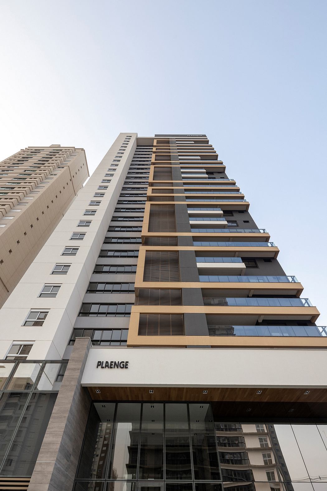 Modern high-rise building with distinct architectural features and glass facade.