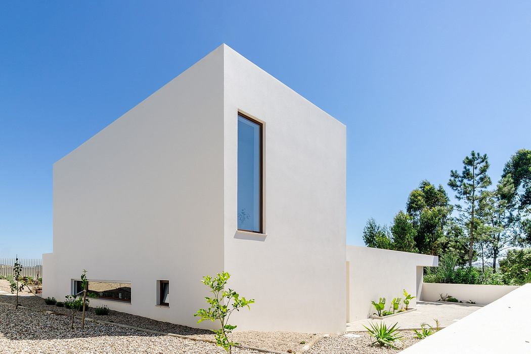 Modern minimalist architectural design with clean lines, minimalist window, and landscaping.
