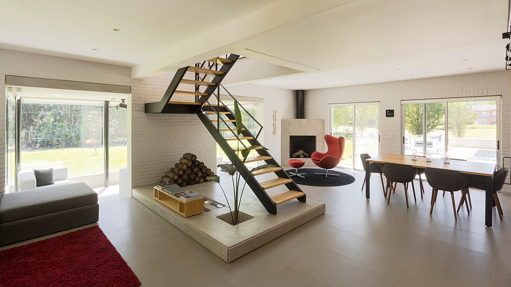 Spacious, modern interior with a striking steel staircase and cozy living area.