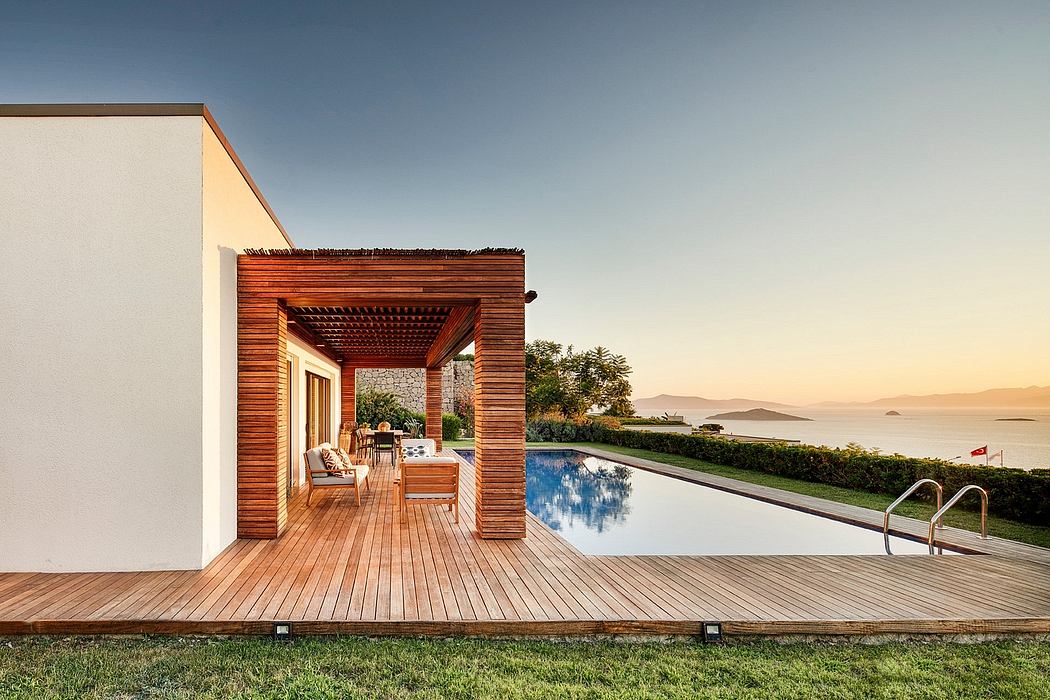 Modern wooden pavilion with infinity pool overlooking a scenic coastal landscape.