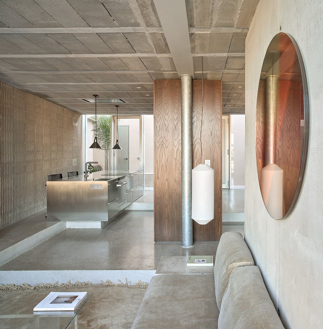 Minimalist interior design with concrete ceiling, wooden panels, and circular mirrors.