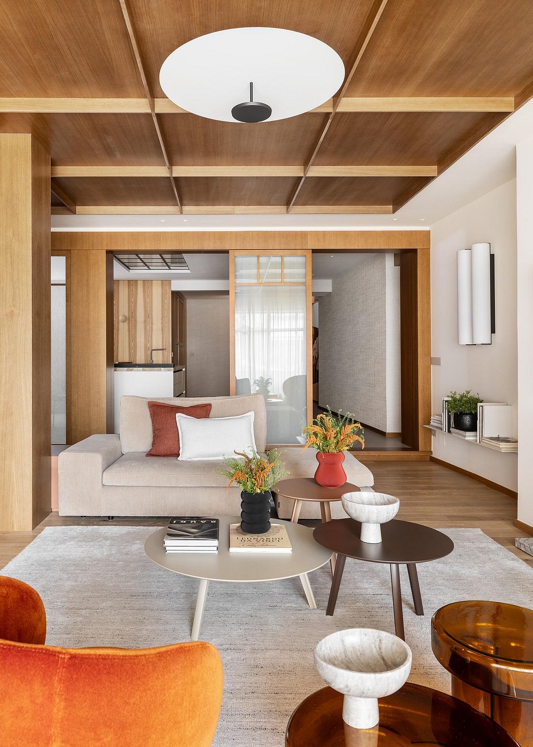 Warm, inviting living space with wooden ceiling beams, plush seating, and modern decor.