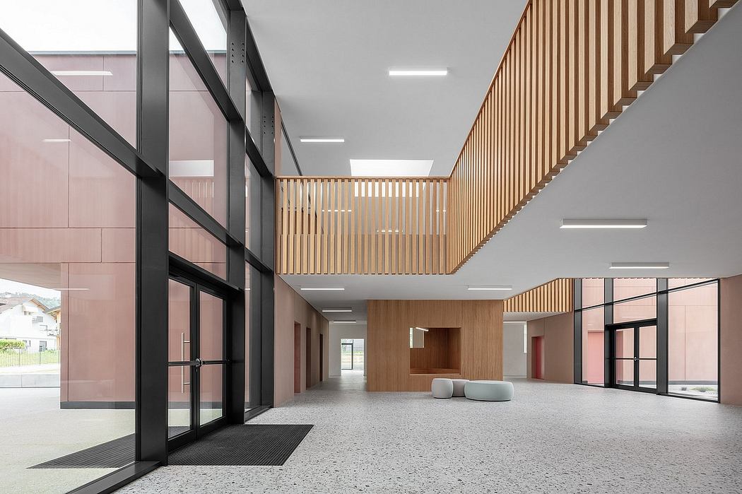 Vast, modern interior with wooden fixtures, glass walls, and terrazzo flooring.