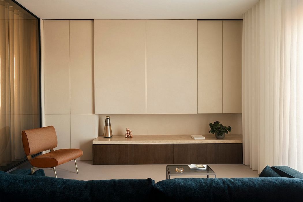 Minimalist living room with built-in cabinetry, neutral color palette, and low-profile furniture.