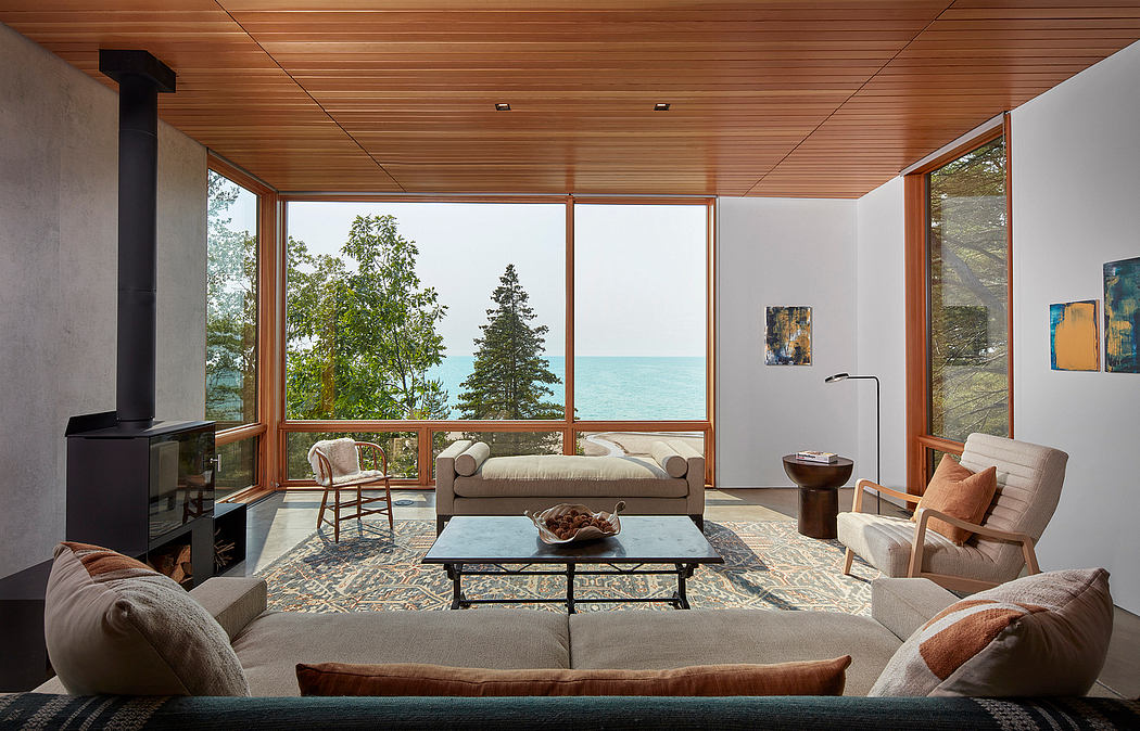 Expansive wood-paneled living room with large windows overlooking the lake.