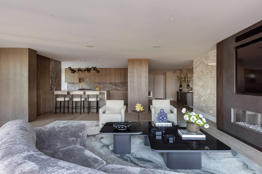 Expansive, modern living space with wood paneling, marble accents, and sleek furnishings.