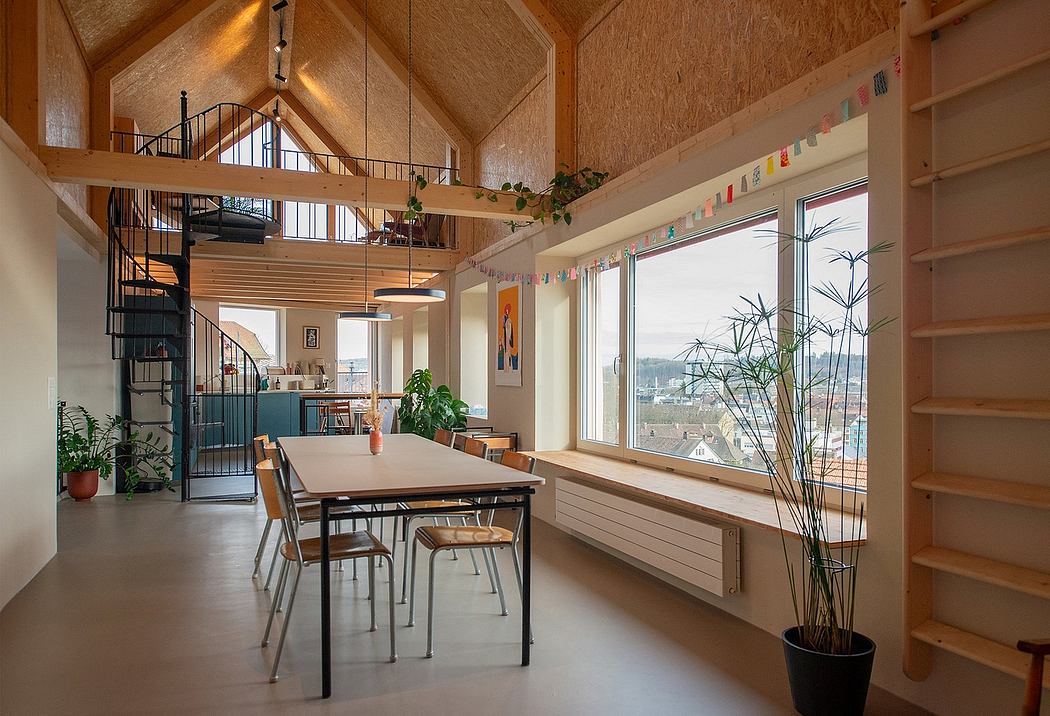 Cozy wooden cabin with vaulted ceiling, loft, and panoramic window overlooking a cityscape.
