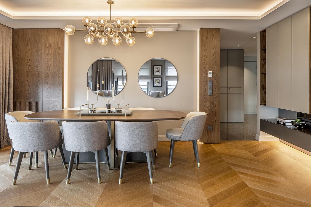 Warm, modern dining room with wooden accents, circular mirrors, and a grand chandelier.