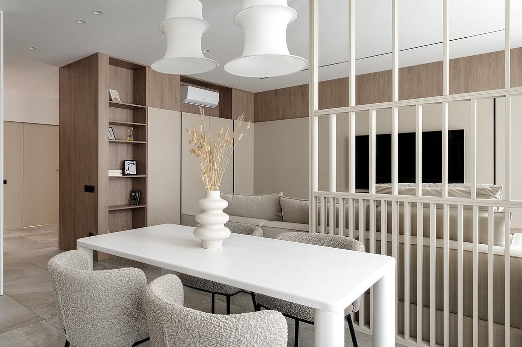 Minimalist living room with neutral tones, sleek furnishings, and modern lighting fixtures.