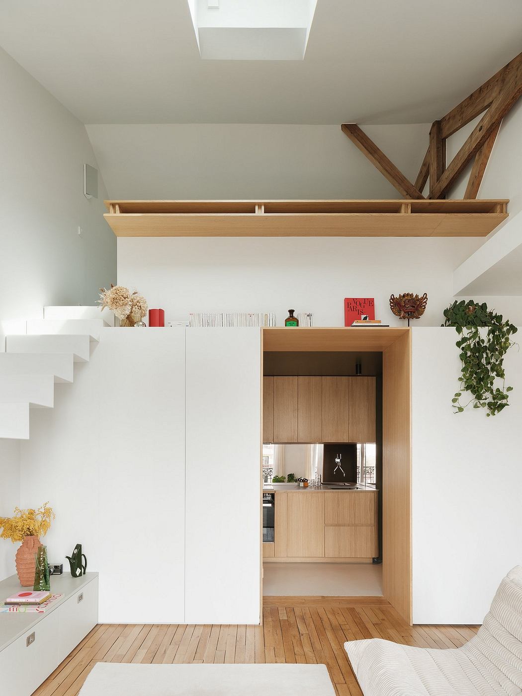 Minimalist studio apartment with wooden accents, built-in storage, and sleek design.