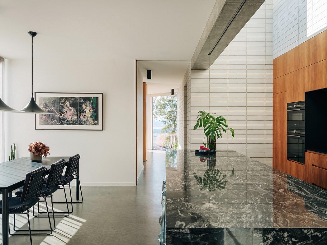 A modern, minimalist interior with concrete beams, tiled floors, and a nature-inspired artwork.